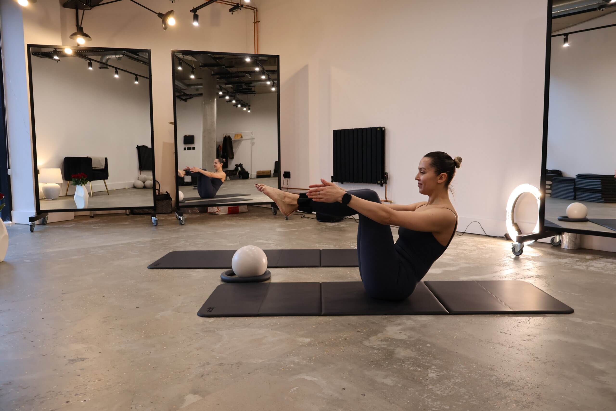 Yoga practitioner practicing a calm standing pose in a peaceful studio
