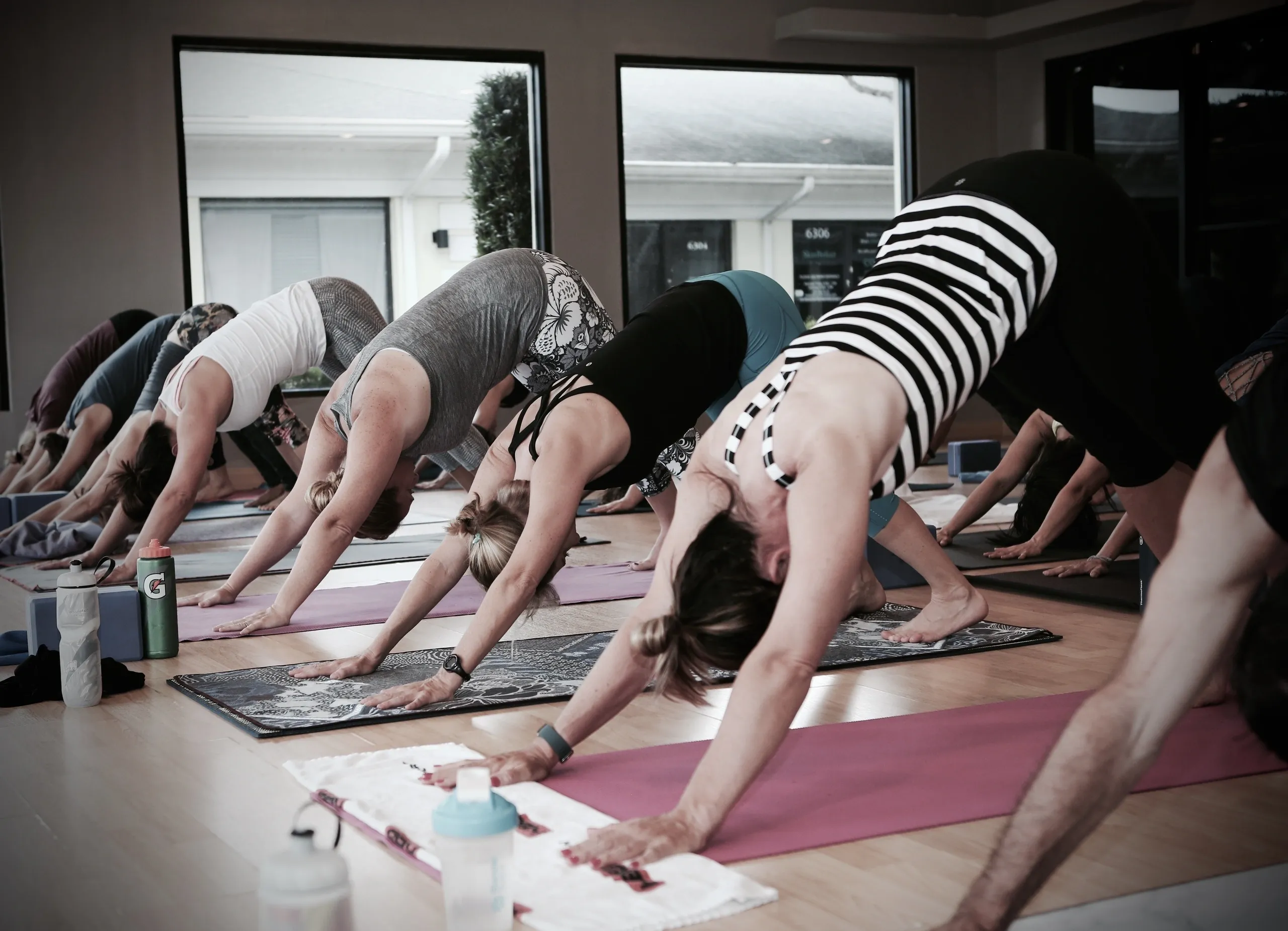 Yoga practitioner moving through a flowing sequence in a peaceful studio