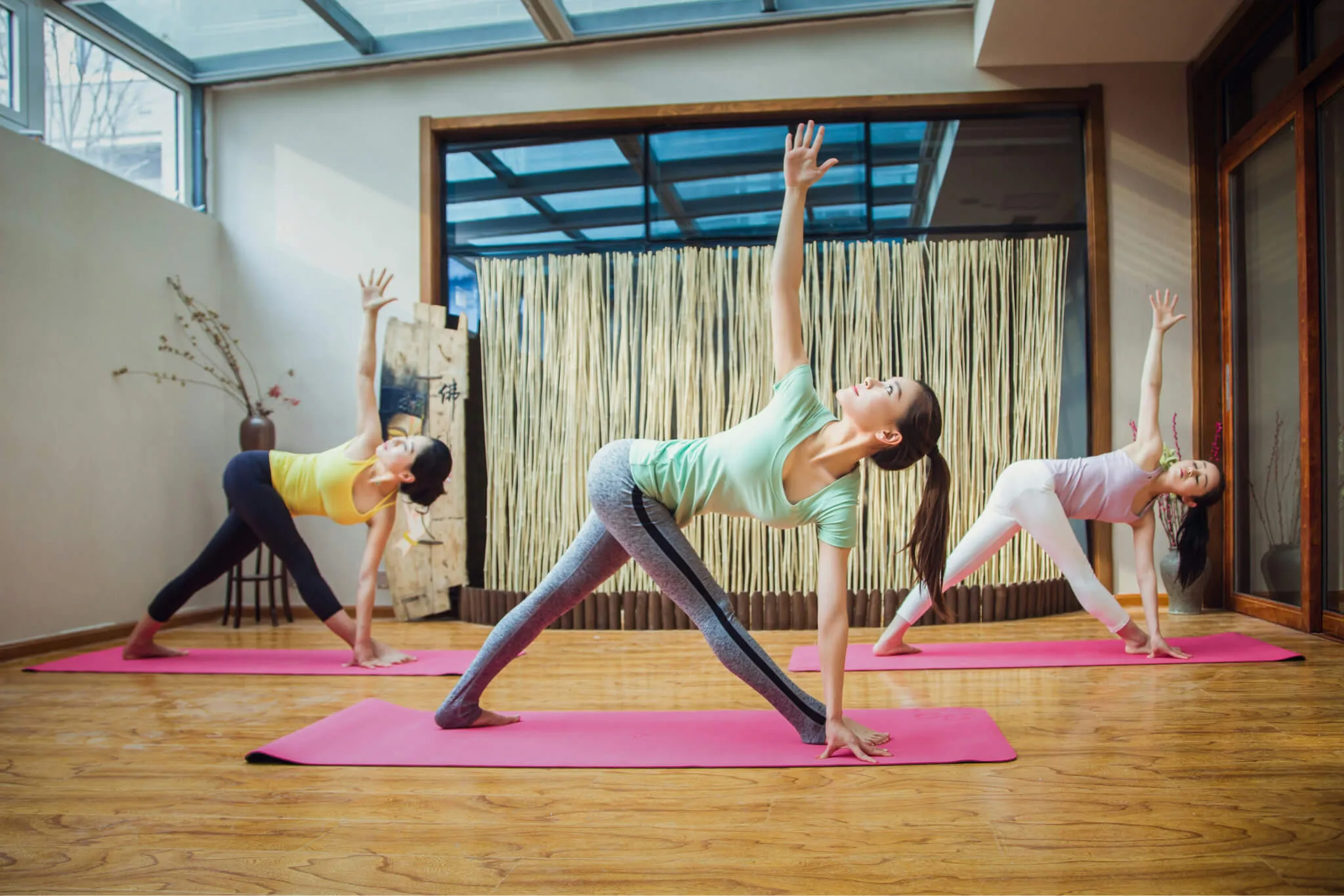 Yoga practitioner moving through a calm sequence in a peaceful studio